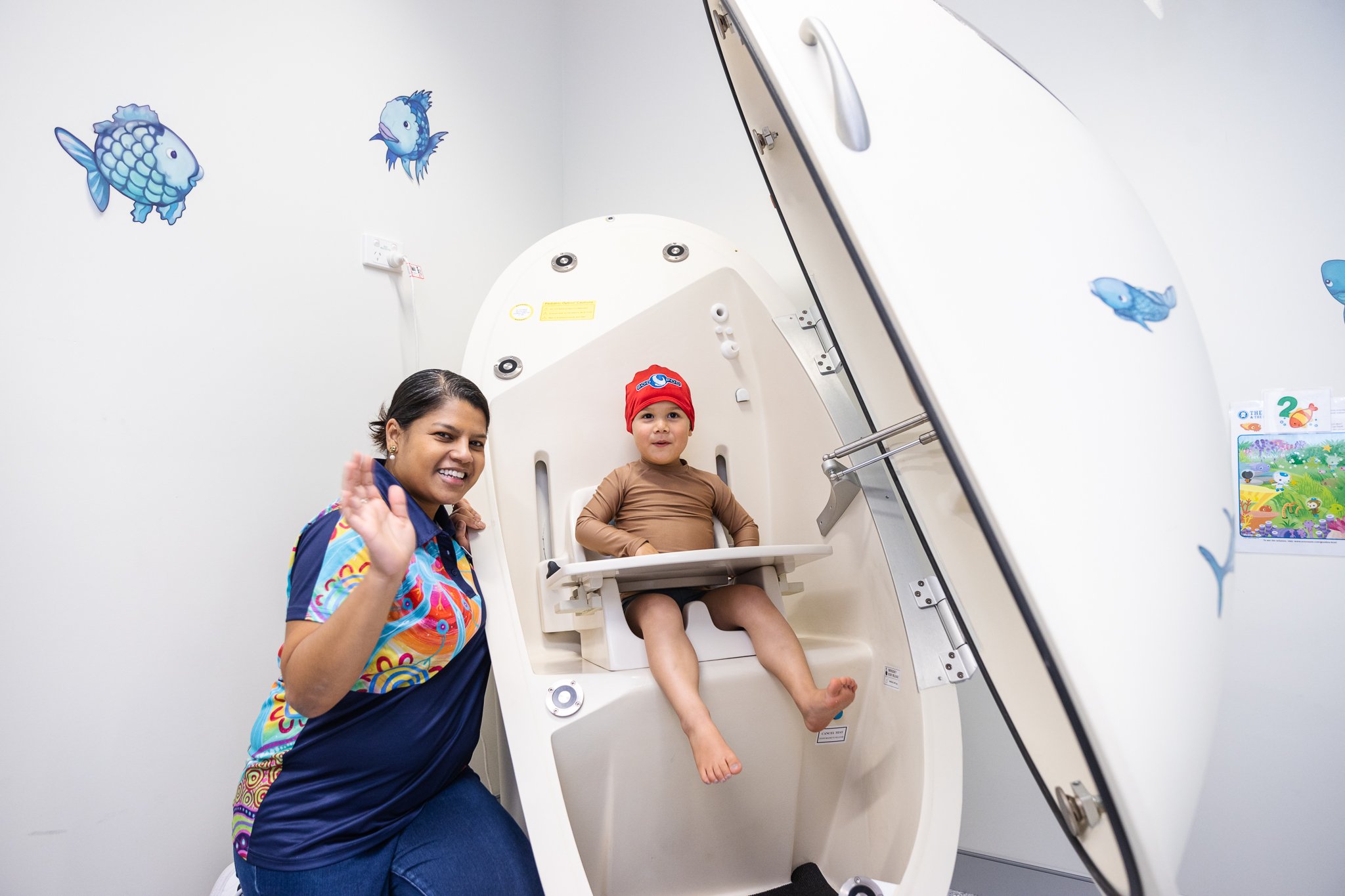 Avril and ORIGINS participant waving in the BodPod